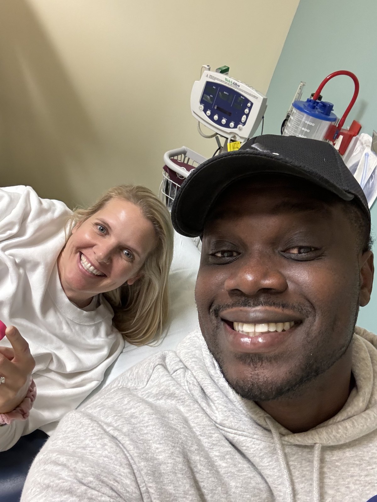 Amy and her partner smiling together in a clinic selfie