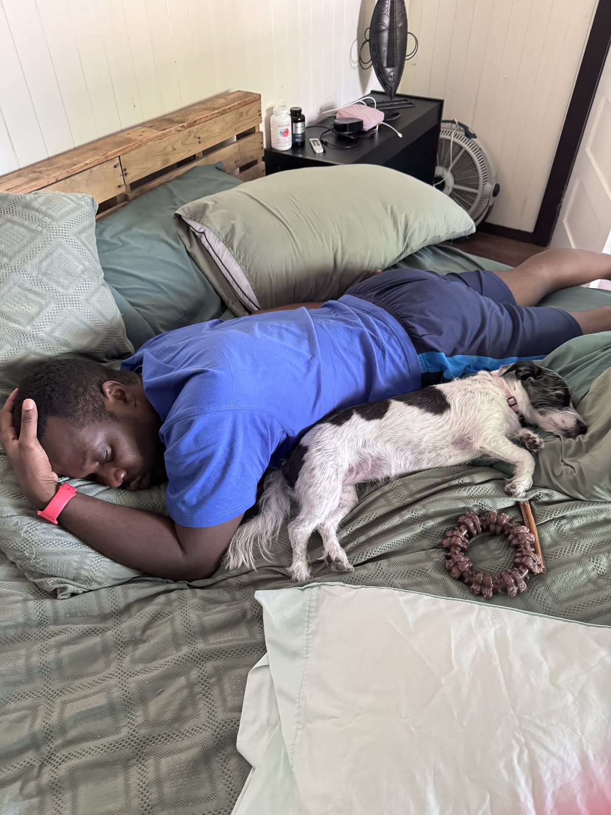 Amy's partner lying down at home with Paisley beside him